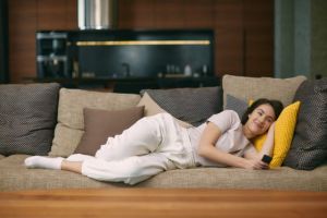 Woman laying on couch recovering from bone graft
