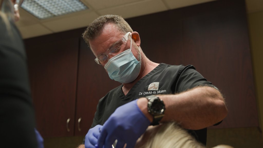 Dr. Moeln working with mask and gloves