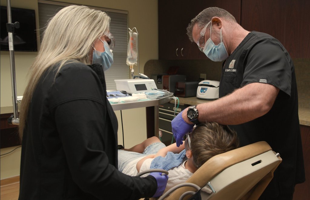 Dr. Molen and assistant working on patient