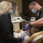 Dr. Molen and assistant working on patient