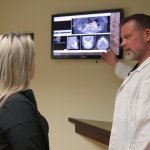 Dr. Molen and patient looking at x-rays